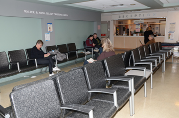 five people sit in a waiting room